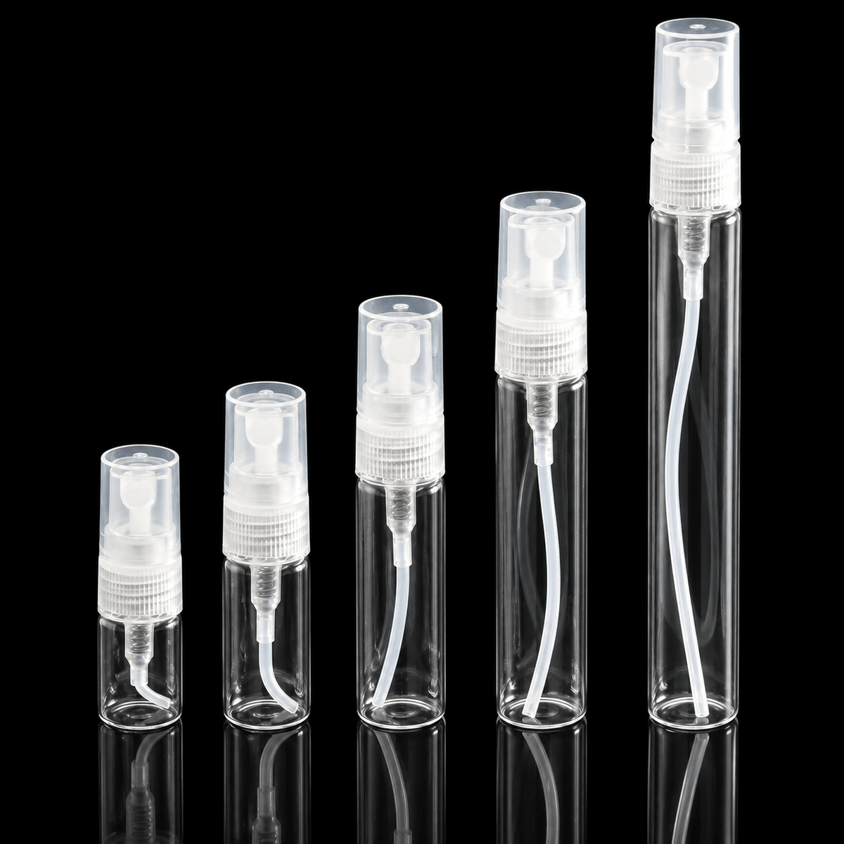 Clear perfume sample atomisers on black background